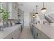 A kitchen with gray cabinets, stone backsplash, stainless steel appliances, and a large island at 7983 Texas Hills St, Las Vegas, NV 89113