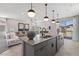 Modern kitchen with a large island, bar stool seating, and an open view to the living area at 7983 Texas Hills St, Las Vegas, NV 89113