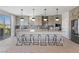 Spacious kitchen with gray cabinets, modern appliances, large island, and bar stool seating at 7983 Texas Hills St, Las Vegas, NV 89113