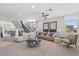 Spacious living room area with stylish furniture and decor featuring access to the staircase and outside views at 7983 Texas Hills St, Las Vegas, NV 89113