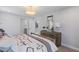 Comfortable bedroom with patterned linens, dresser with mirror, and bathroom access at 7983 Texas Hills St, Las Vegas, NV 89113