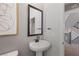 Clean powder room featuring a modern vanity, sleek mirror, and elegant art at 7983 Texas Hills St, Las Vegas, NV 89113