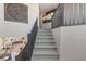 Carpeted staircase leads to an open living area with a fireplace, creating a welcoming atmosphere at 7983 Texas Hills St, Las Vegas, NV 89113