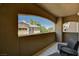 Inviting balcony area with outdoor seating, overlooking landscaped surroundings and neighborhood buildings at 8717 Red Brook Dr # 201, Las Vegas, NV 89128