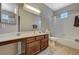 Bathroom featuring a vanity, tiled floor and walls, a soaking tub and large mirror at 8717 Red Brook Dr # 201, Las Vegas, NV 89128