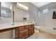 Well-lit bathroom with a spacious vanity, a shower-tub combo, and decorative tiles at 8717 Red Brook Dr # 201, Las Vegas, NV 89128
