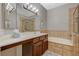 Bathroom featuring a vanity, tile surround soaking tub and tile flooring at 8717 Red Brook Dr # 201, Las Vegas, NV 89128