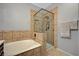 Bathroom featuring a soaking tub, tile surround shower and tile flooring at 8717 Red Brook Dr # 201, Las Vegas, NV 89128