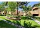 A complex of apartments with flowering shrubs between residences and mature shade trees at 8717 Red Brook Dr # 201, Las Vegas, NV 89128