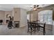 Carpeted dining area featuring a ceiling fan and a modern table with chairs at 8717 Red Brook Dr # 201, Las Vegas, NV 89128