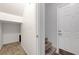 The foyer has neutral walls, carpeted stairs, and access to storage space making for a great arrival at 8717 Red Brook Dr # 201, Las Vegas, NV 89128