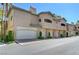 Charming condo building with multiple attached garages and desert landscaping at 8717 Red Brook Dr # 201, Las Vegas, NV 89128