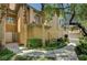 Inviting entryway with a well-maintained lawn and mature palm trees at 8717 Red Brook Dr # 201, Las Vegas, NV 89128