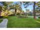 Well-maintained grounds with lush green lawn, mature trees, and manicured landscaping at 8717 Red Brook Dr # 201, Las Vegas, NV 89128