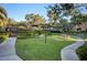 Well-maintained grounds with lush green lawn, mature trees, and manicured landscaping at 8717 Red Brook Dr # 201, Las Vegas, NV 89128