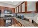 Bright kitchen features granite countertops, wood cabinetry and stainless steel appliances at 8717 Red Brook Dr # 201, Las Vegas, NV 89128