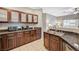 Open kitchen with granite countertops, stainless steel appliances, and wood cabinets at 8717 Red Brook Dr # 201, Las Vegas, NV 89128