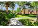 Inviting pathway through a well-manicured lawn with palm trees and flowering shrubs at 8717 Red Brook Dr # 201, Las Vegas, NV 89128