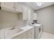 Laundry room featuring a sink, white cabinetry and white washer and dryer at 8717 Red Brook Dr # 201, Las Vegas, NV 89128