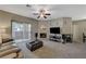 Open living area with fireplace, balcony access, and ceiling fan at 8717 Red Brook Dr # 201, Las Vegas, NV 89128