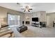 Open living room with a fireplace, ceiling fan, and access to outdoor patio at 8717 Red Brook Dr # 201, Las Vegas, NV 89128