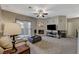 Spacious living room with fireplace, media setup and sliding glass doors to balcony at 8717 Red Brook Dr # 201, Las Vegas, NV 89128