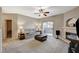 Spacious living room featuring a fireplace, sliding glass doors, and neutral carpet at 8717 Red Brook Dr # 201, Las Vegas, NV 89128