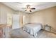 Well-lit main bedroom featuring a ceiling fan, connecting doors to a bathroom, and a dresser at 8717 Red Brook Dr # 201, Las Vegas, NV 89128