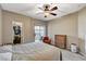 Cozy main bedroom showcasing a ceiling fan, walk-in closet, and access to a balcony at 8717 Red Brook Dr # 201, Las Vegas, NV 89128
