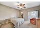 Comfortable main bedroom featuring a ceiling fan, carpet, and sliding door to the outside at 8717 Red Brook Dr # 201, Las Vegas, NV 89128