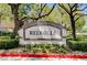 The Redhills community sign surrounded by greenery at 8717 Red Brook Dr # 201, Las Vegas, NV 89128