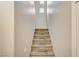 Carpeted stairs leading to the upper level with a small window for added light at 8717 Red Brook Dr # 201, Las Vegas, NV 89128