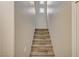 Carpeted stairs lead up, illuminated by a small window at 8717 Red Brook Dr # 201, Las Vegas, NV 89128