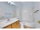 Bright bathroom featuring a single vanity, large mirror, and a shower over tub with tiled walls at 8849 Pheasant Valley Way, Las Vegas, NV 89123