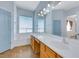 Well-lit bathroom with a large vanity area, separate tub, and neutral blue decor at 8849 Pheasant Valley Way, Las Vegas, NV 89123