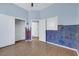 Spacious bedroom with blue paint, wood laminate flooring, and a walk in closet at 8849 Pheasant Valley Way, Las Vegas, NV 89123