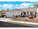 Single-story home boasts a two-car garage and a well-maintained front yard with desert landscaping at 8849 Pheasant Valley Way, Las Vegas, NV 89123