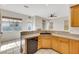 Spacious kitchen featuring stone counters, light wood cabinets, stainless steel appliances, and tile floors at 8849 Pheasant Valley Way, Las Vegas, NV 89123