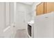 Functional laundry area featuring a washer, dryer, and storage cabinets at 8849 Pheasant Valley Way, Las Vegas, NV 89123