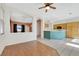 Open-concept living area featuring hardwood floors, neutral walls, and an open view to the kitchen at 8849 Pheasant Valley Way, Las Vegas, NV 89123