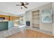 Cozy living room with fireplace, built-in shelving, and an adjacent kitchen area at 8849 Pheasant Valley Way, Las Vegas, NV 89123