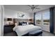 Serene main bedroom featuring large windows and a stylish ceiling fan at 899 Apatite Pl # Lot 61, Henderson, NV 89011