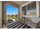 Cozy balcony features a table, chairs, and stylish black-and-white striped rug, perfect for relaxing outdoors at 965 Nevada State Dr # 41201, Henderson, NV 89002