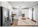 Bright kitchen with white cabinets, stainless steel appliances, a marble-look island, and wood-look flooring at 965 Nevada State Dr # 41201, Henderson, NV 89002