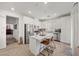 Modern kitchen featuring white cabinets, stainless steel appliances, a kitchen island with bar seating, and wood-look flooring at 965 Nevada State Dr # 41201, Henderson, NV 89002