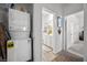 Laundry area with washer/dryer combo and a view into a bathroom with white cabinets at 965 Nevada State Dr # 41201, Henderson, NV 89002