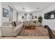 Modern living room featuring neutral tones, comfortable seating, a decorative rug, and a large-screen television at 965 Nevada State Dr # 41201, Henderson, NV 89002