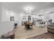 Open-concept living space with modern lighting, a kitchen island, stainless steel appliances, and wood-look flooring at 965 Nevada State Dr # 41201, Henderson, NV 89002