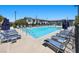 A community pool with plenty of lounge chairs and a beautiful view of the surrounding landscaping and nearby buildings at 965 Nevada State Dr # 41201, Henderson, NV 89002