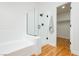 Bright bathroom featuring a tub, glass enclosed shower and walk-in closet at 9741 Horizon Hills Dr, Las Vegas, NV 89117